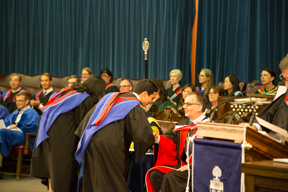 Students are called to the stage and following, they receive their diplomas