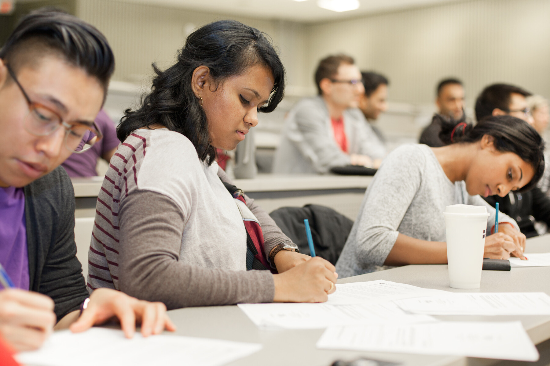Students writing in a lecture hall
