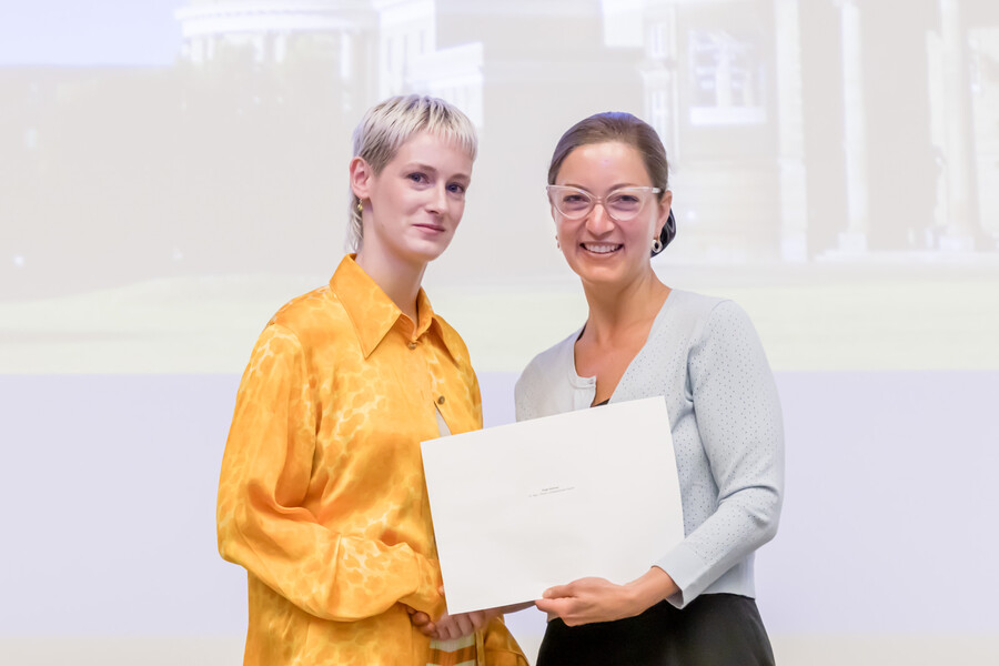 Paige Homme receives an award and is pictured with Professor Danielle Martin