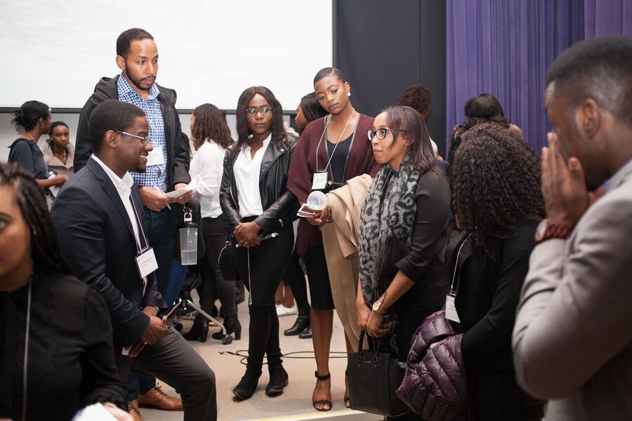 DR. AYO ODUTAYO SPEAKS WITH STUDENTS.